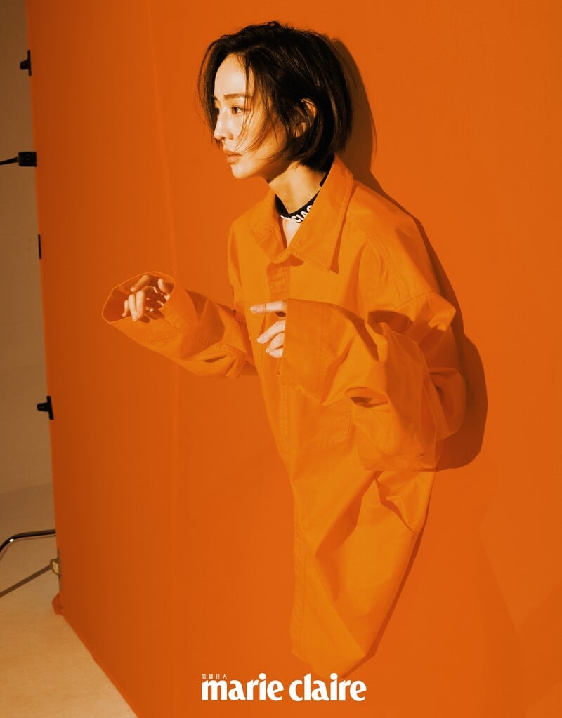 橘色襯衫、短褲、橡膠字母頸鍊，all by Balenciaga。
